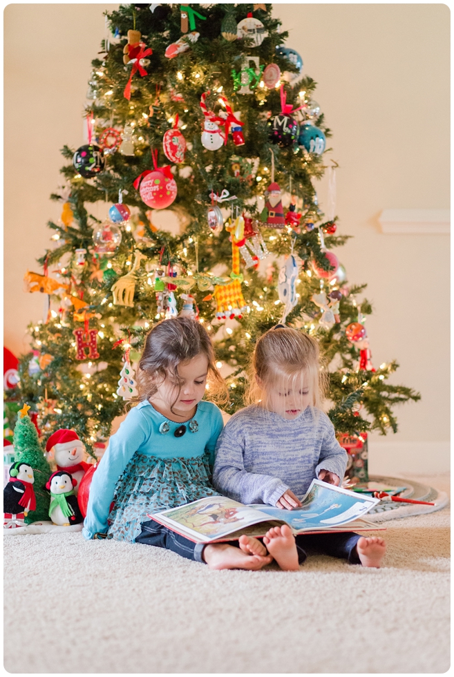 sisters reading books by the Christmas tree