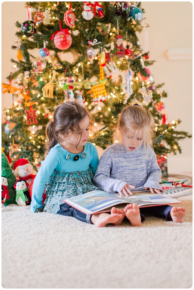 sisters reading books by the Christmas tree